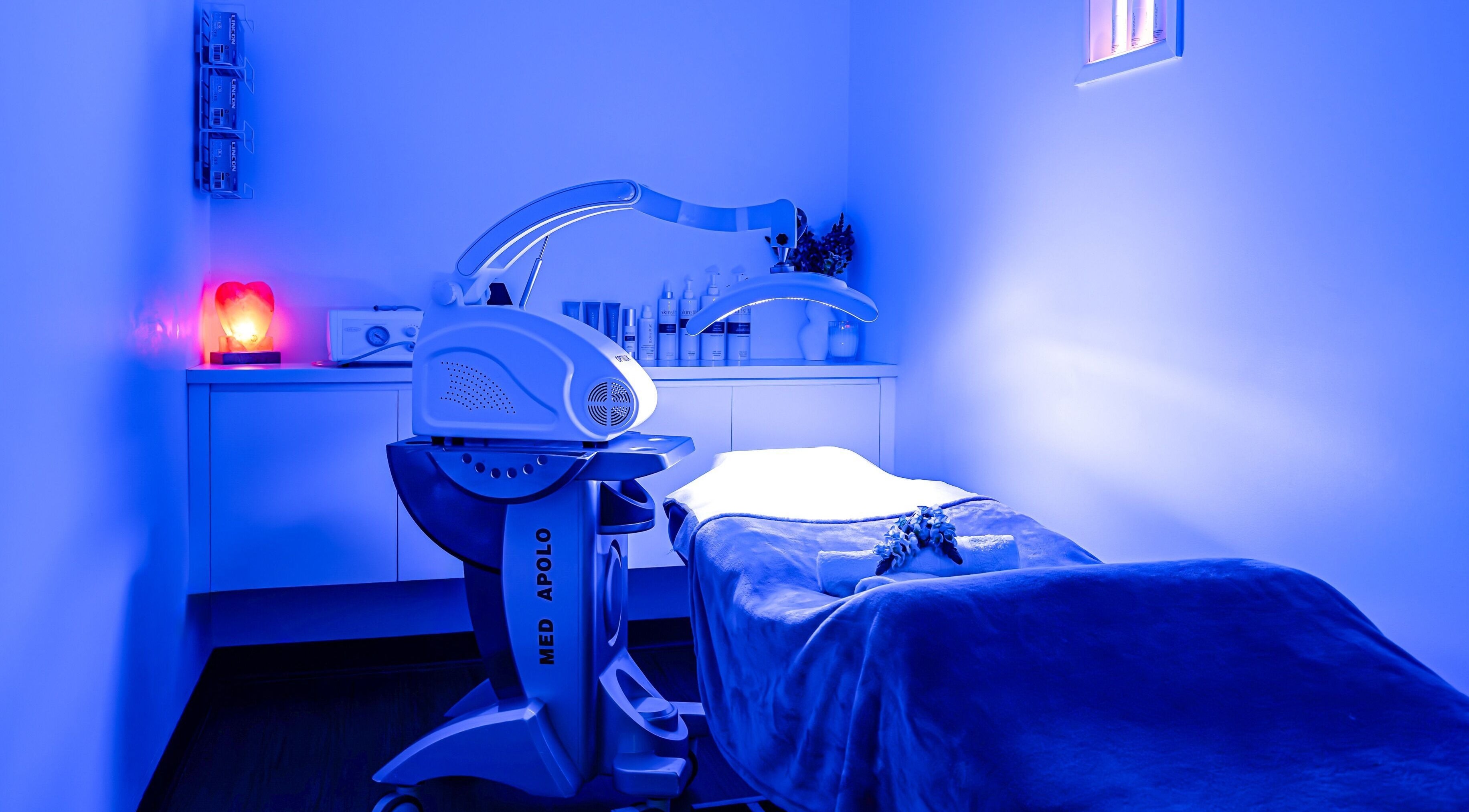 Tranquil treatment room at Face Magic Medispa, Coolangatta, Queensland, AU, with modern equipment and soothing blue light.