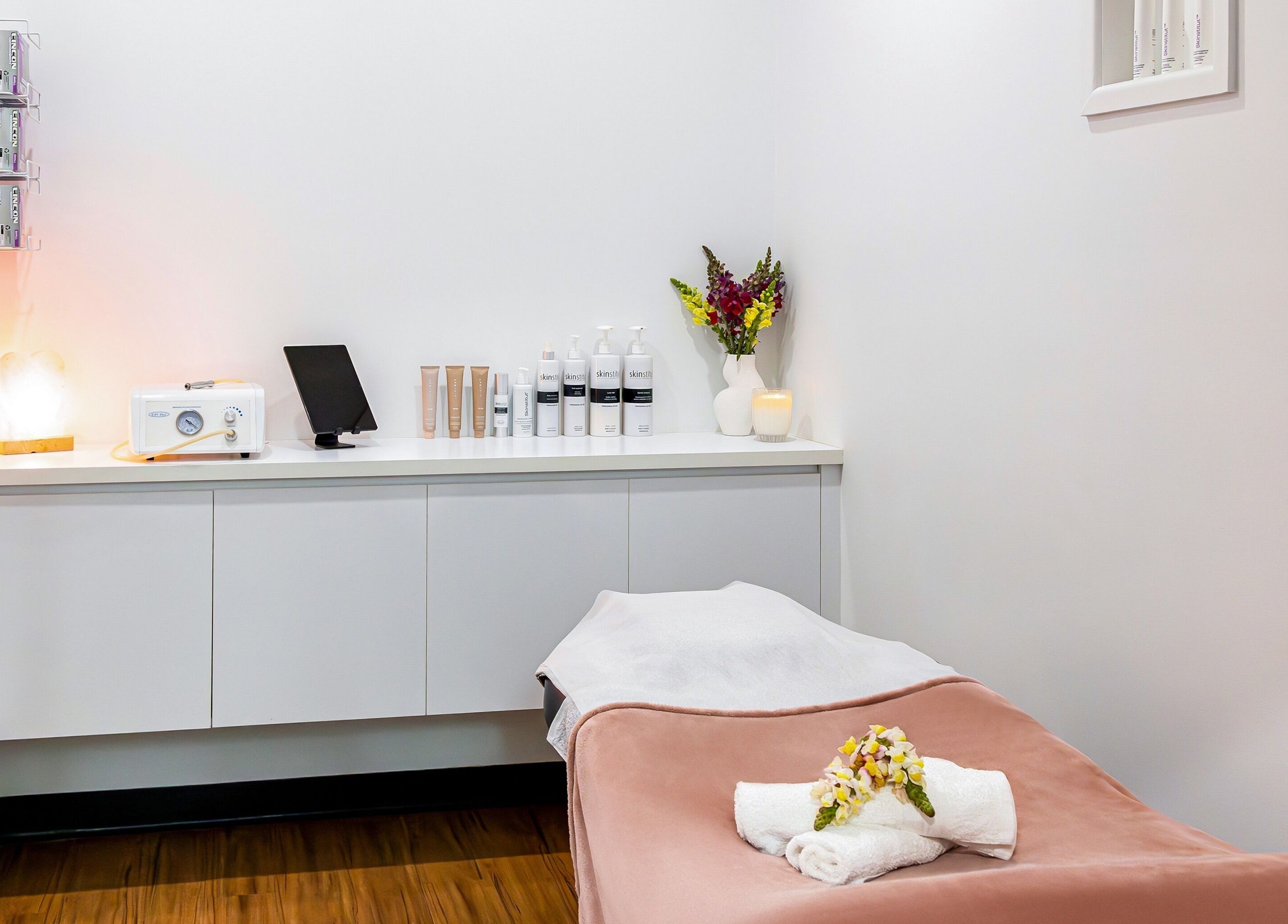 Tranquil treatment room at Face Magic Medispa in Coolangatta, Queensland, AU with soft lighting and skincare products.