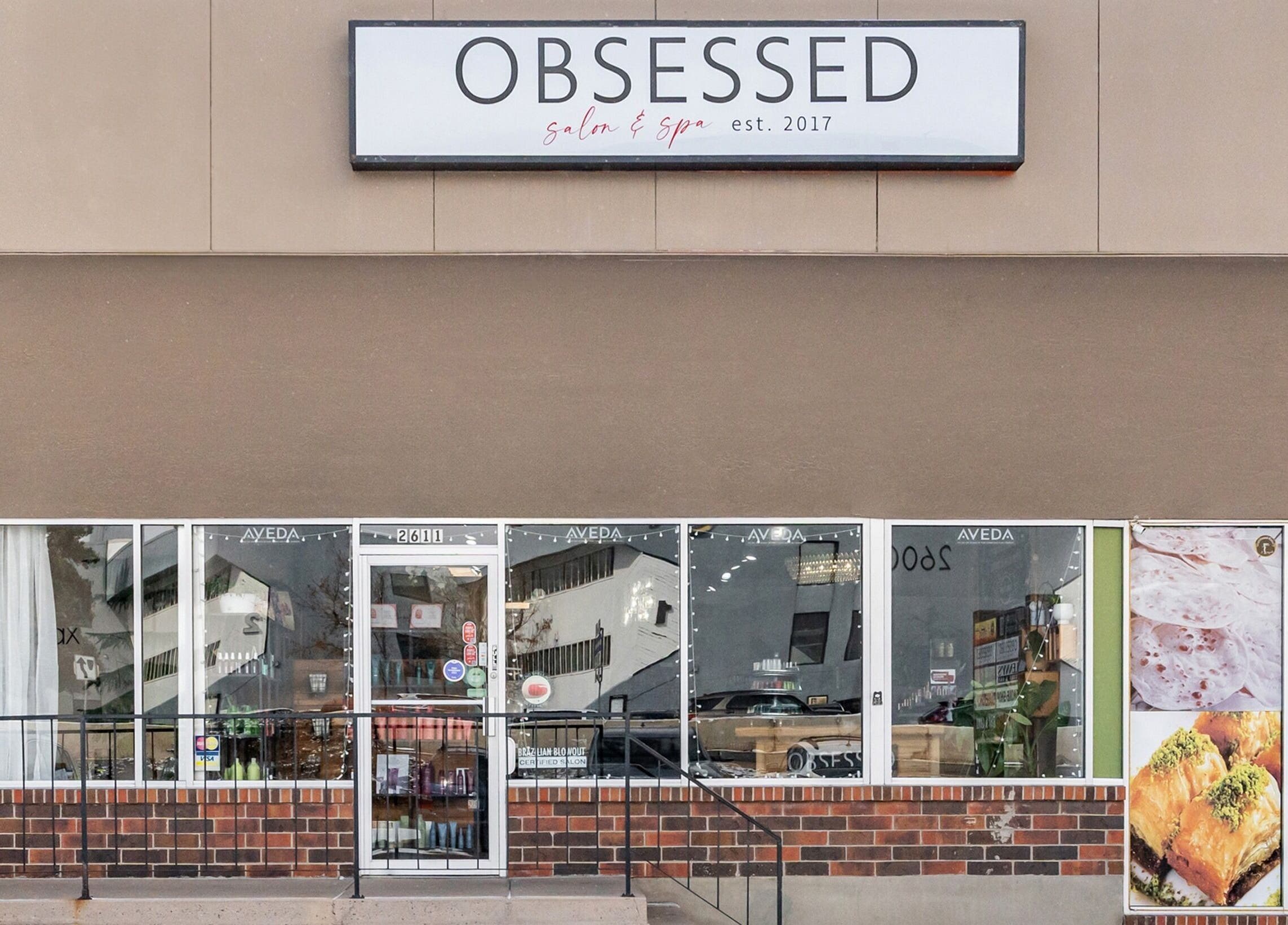 Front view of Obsessed Salon in Aurora, Colorado, US showcasing modern salon and spa entrance.