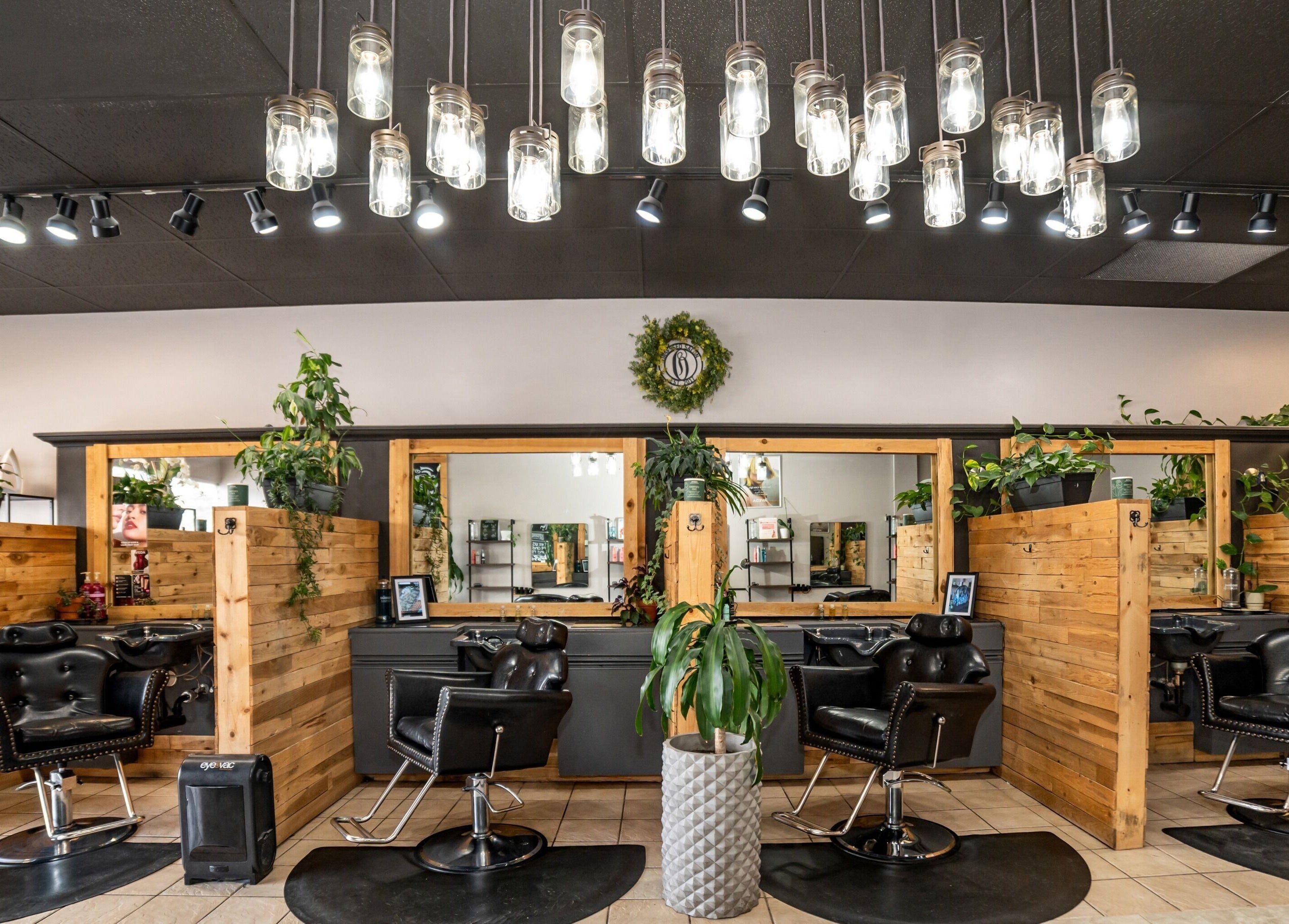 Cozy hair salon booths with wooden decor at Obsessed Salon, Aurora, Colorado, US.