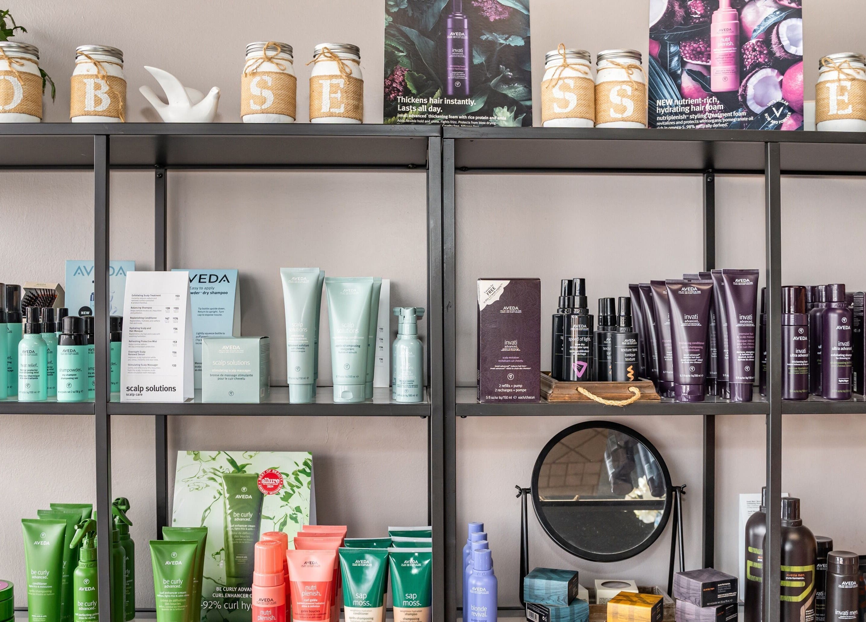 Product shelves at Obsessed Salon, Aurora, Colorado, US showcasing premium beauty items.