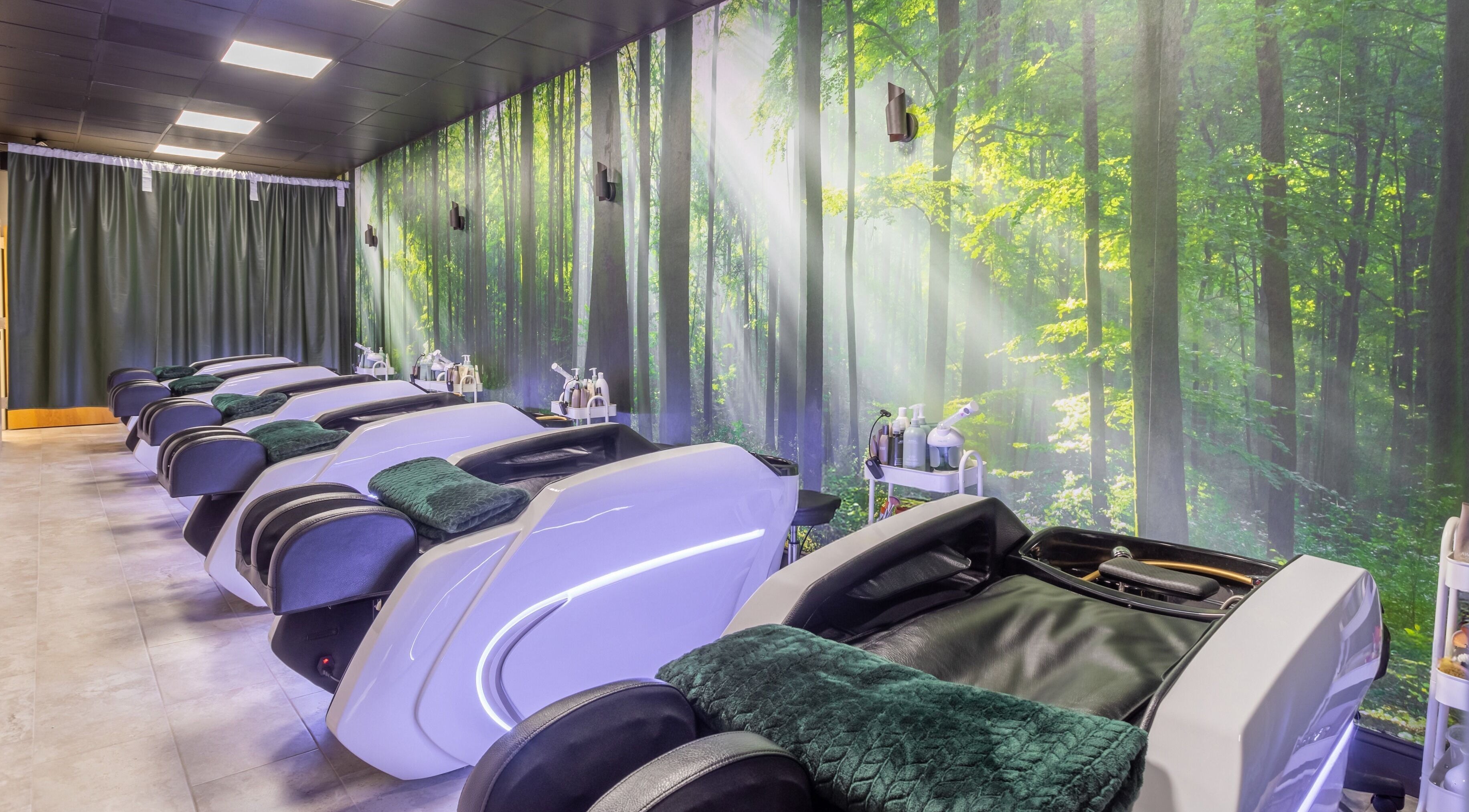 Serene ambiance with recliners at Obsessed Head Spa, Aurora, Colorado, US surrounded by forest-themed decor.