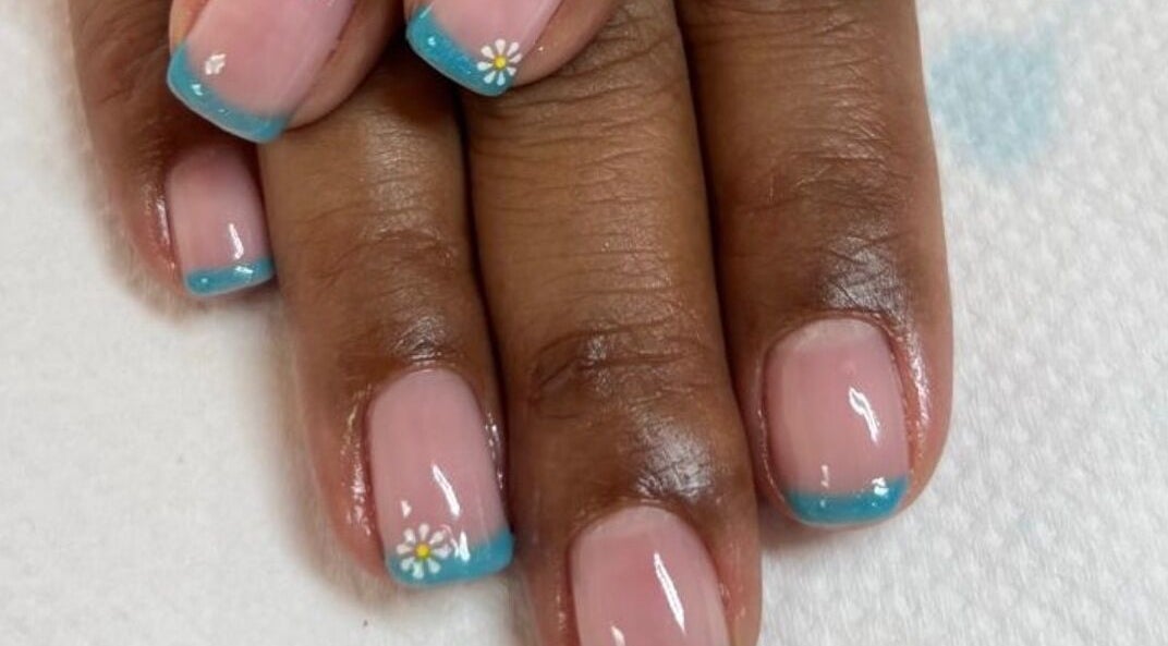Elegant blue-tipped manicure with floral art at Pamper Me Pink, Cape Town, Western Cape, ZA.
