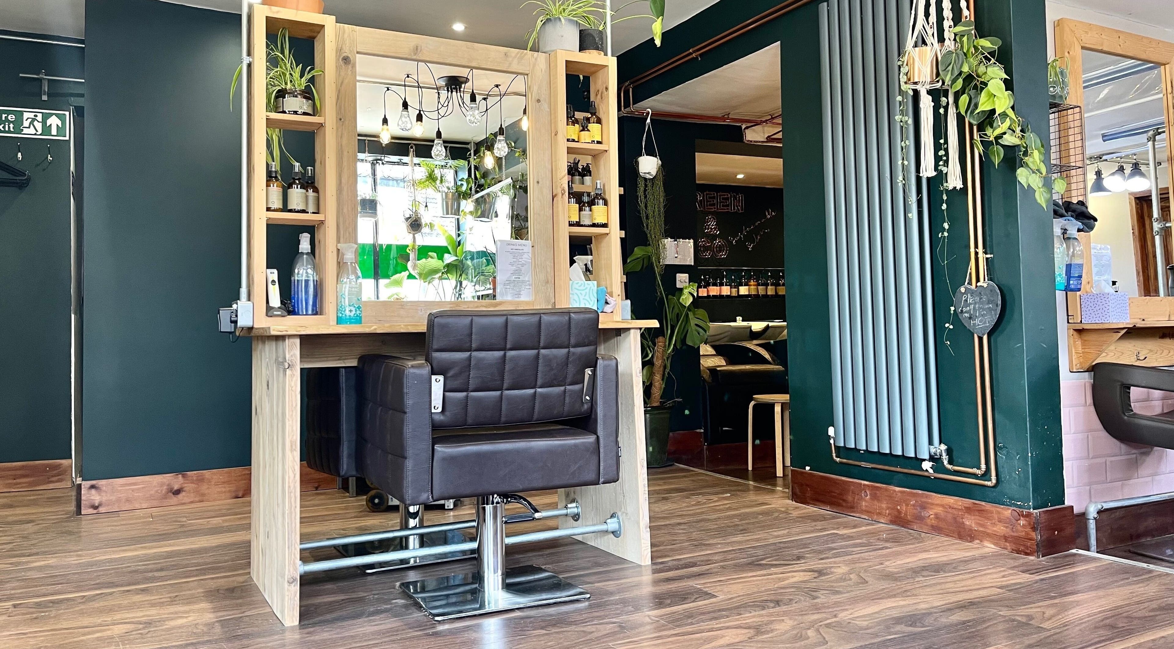 Trendy salon chair at Green & Co in Ripon, England, GB with stylish decor and vibrant plants.