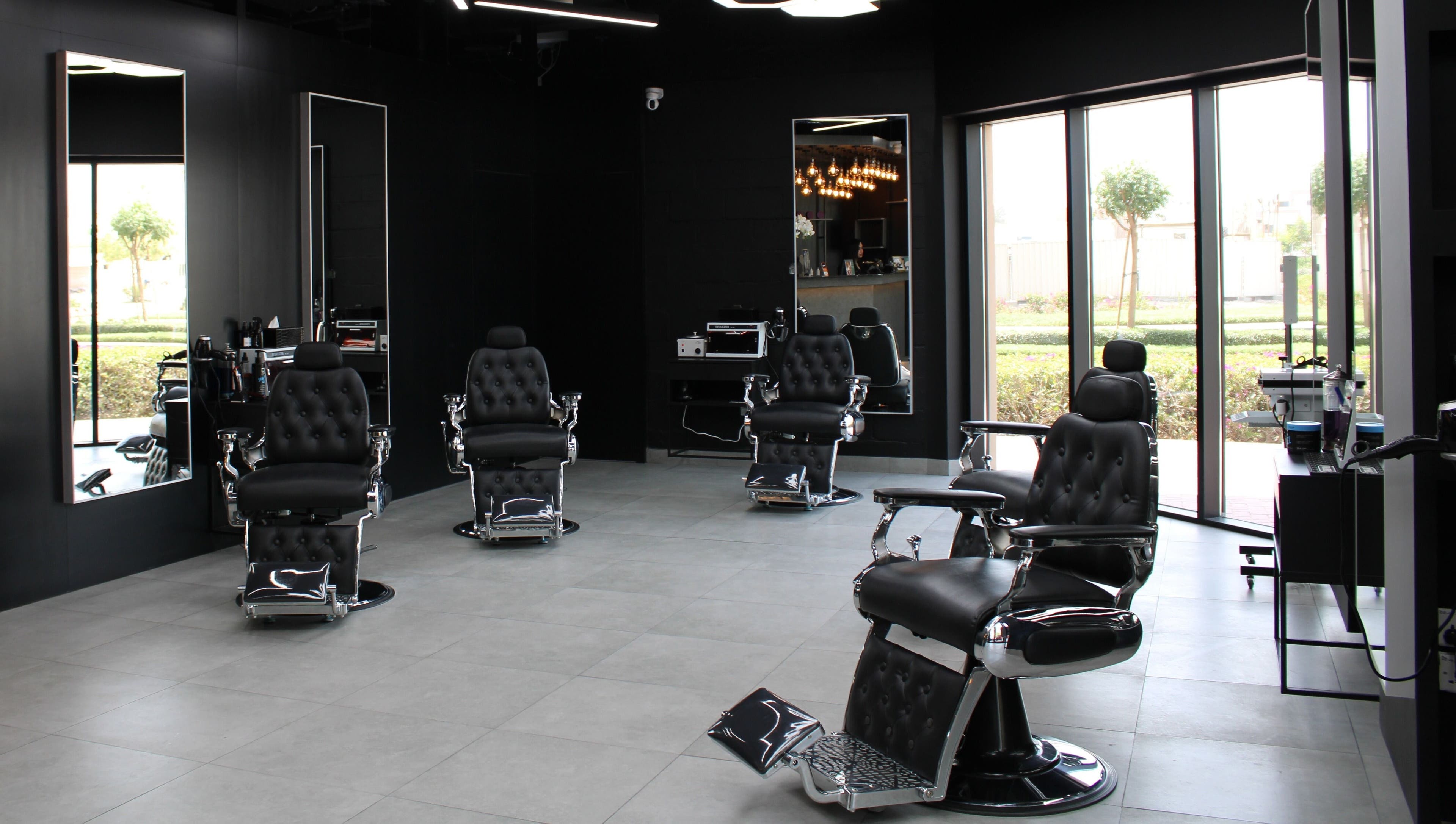 Interior of Moe's Lounge - Jumeirah Garden City, Dubai, AE with sleek barber chairs and modern decor.