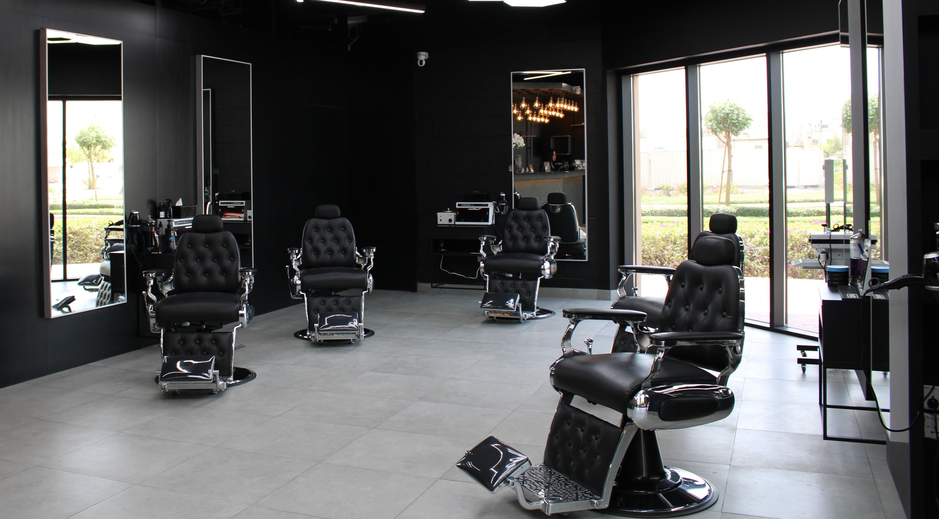 Interior of Moe's Lounge - Jumeirah Garden City, Dubai, AE with sleek barber chairs and modern decor.