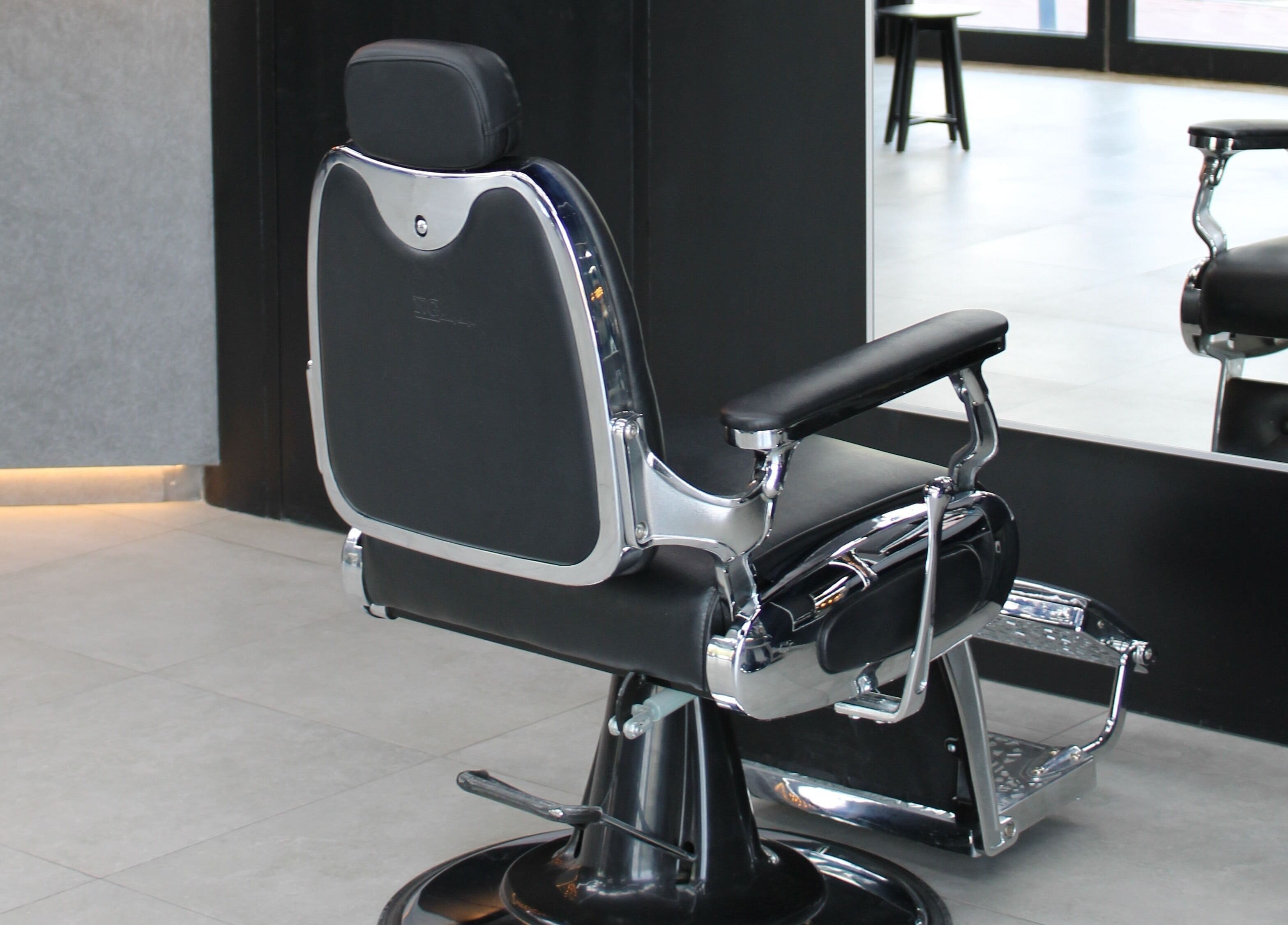 Sleek barber chair at Moe's Lounge - Jumeirah Garden City, Dubai, AE for premium grooming services.