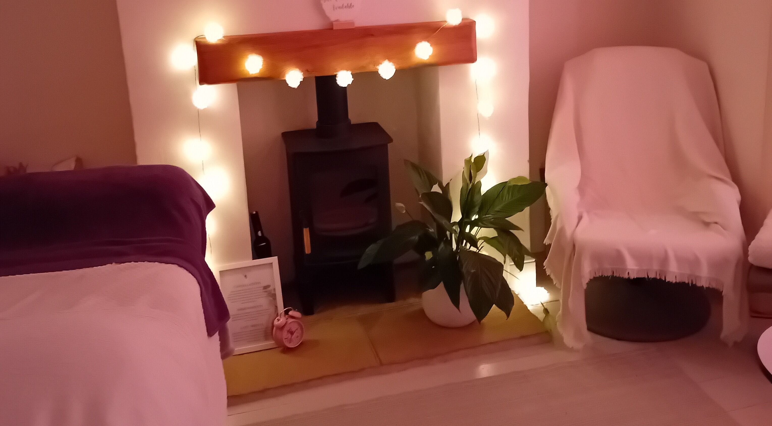 Warm, inviting therapy room at Artiste Beauty (Sidmouth), Sidmouth, GB, featuring soft lighting and cozy seating.