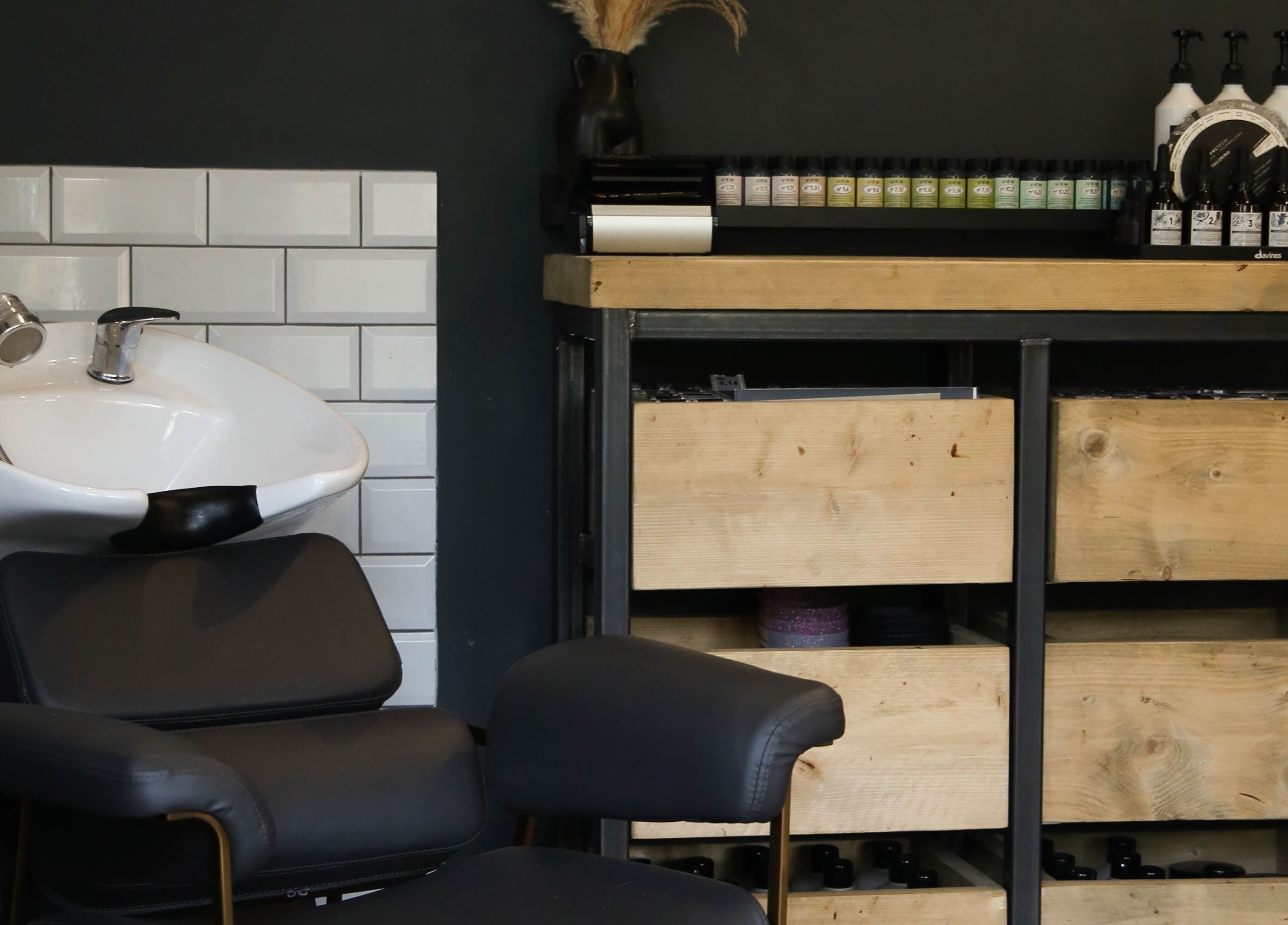 Stylish salon wash station and product shelf in Mane, Huncote, England, GB.