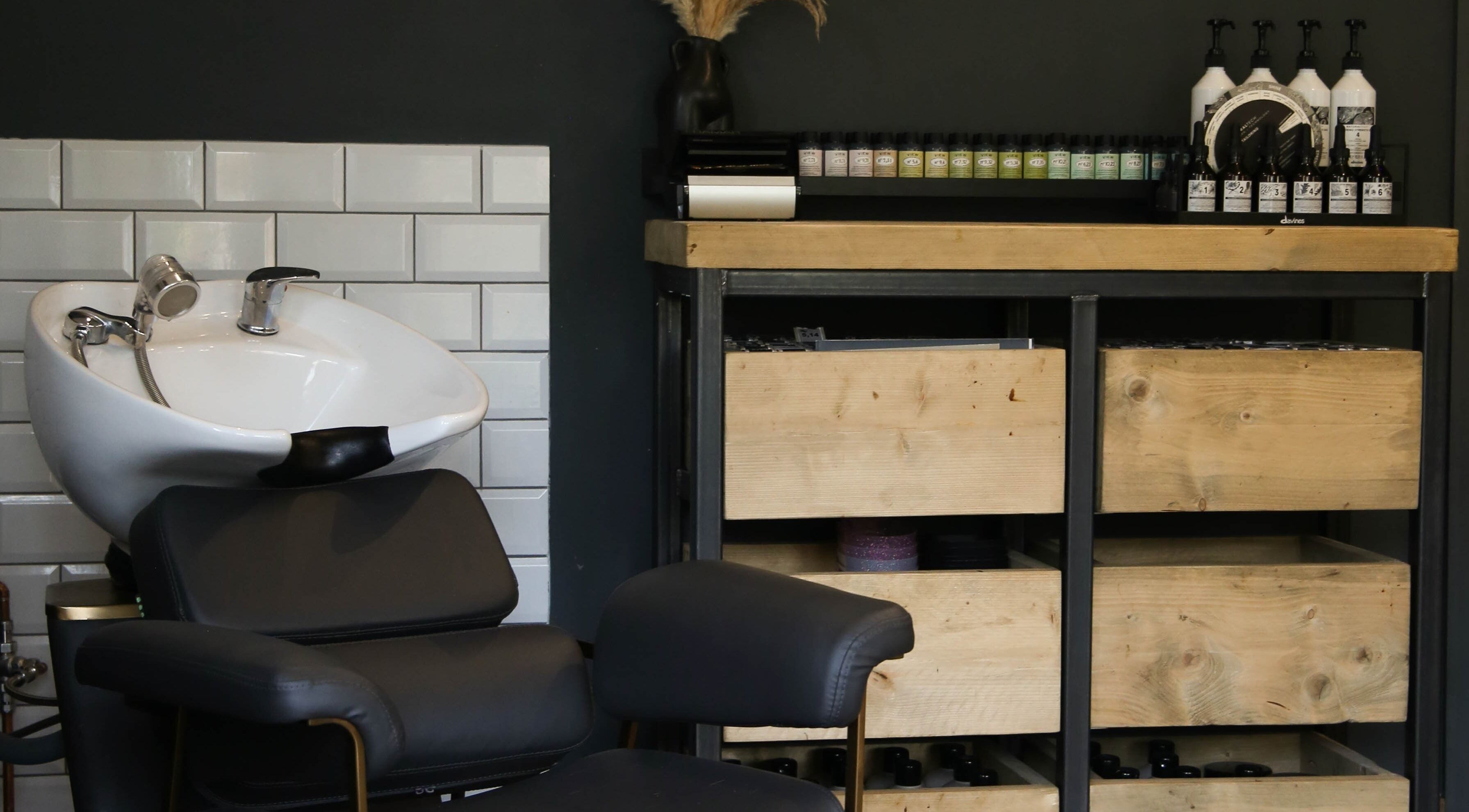 Stylish salon wash station and product shelf in Mane, Huncote, England, GB.