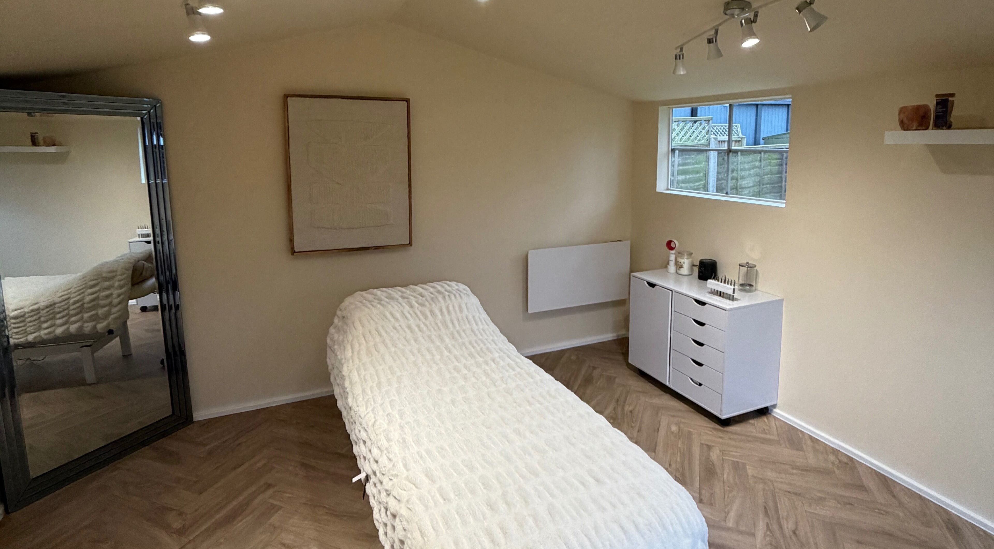 Elegant treatment room at Lashbyboo, Portsmouth, England, GB, featuring a cozy bed and soothing decor.