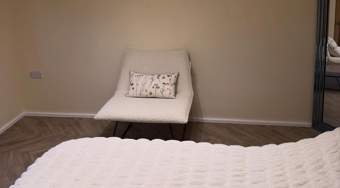 Comfortable chair with floral cushion in Lashbyboo, Portsmouth, England, GB's relaxing session room.