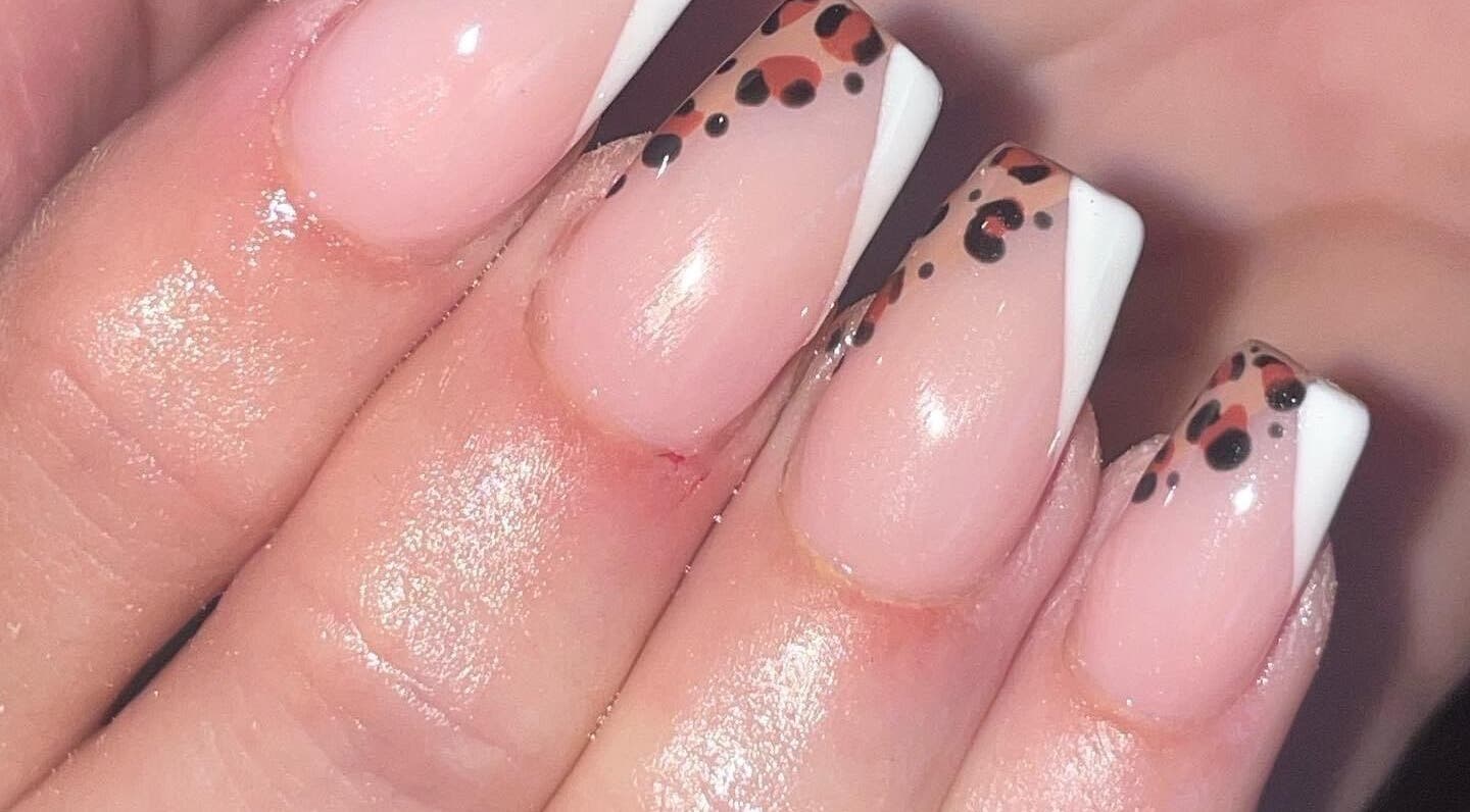 Elegant nude nails with leopard tips at Ella Rose Nails, Witham, England, GB.