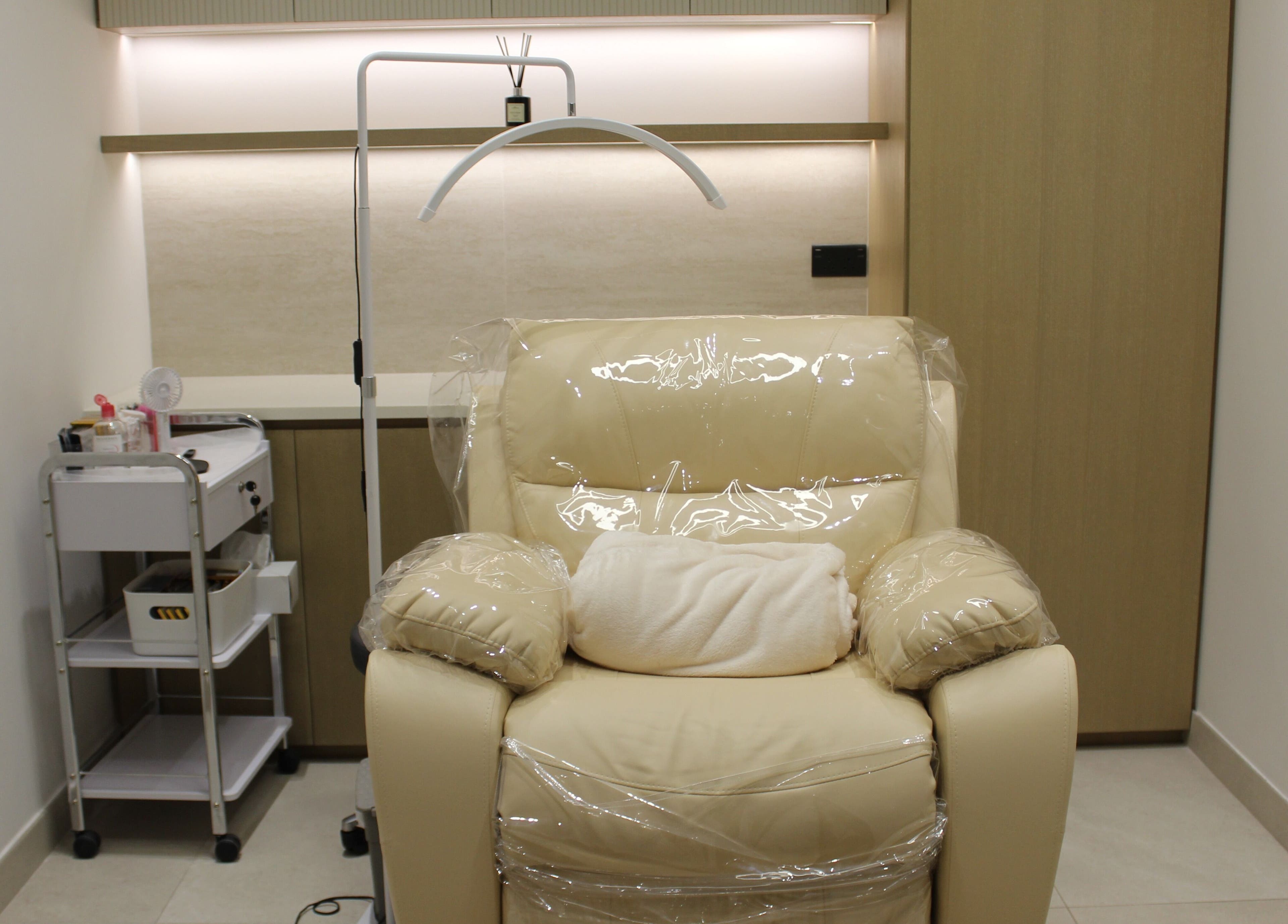 Cozy treatment room with plush chair at By Mikas Beauty Salon - Sole Proprietorship L.L.C., Abu Dhabi, Abu Dhabi, AE.