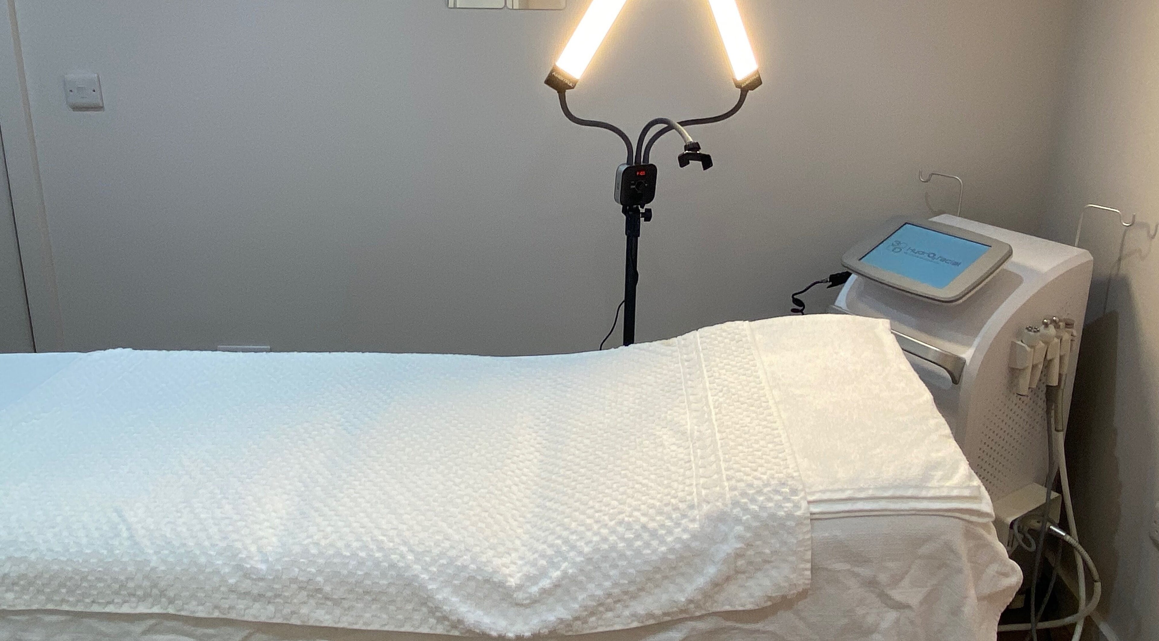 Aesthetic treatment room at Maritza Aesthetics in Portsmouth, England, GB with a prepared massage table.