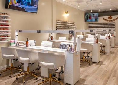 Lover's Nails Spa Kissimmee showcases stylish workstations in Kissimmee, Florida, US, with sleek white chairs.