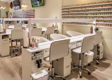Modern nail salon at Lover's Nails Spa Kissimmee, Florida, US with elegant white decor and full nail polish display.