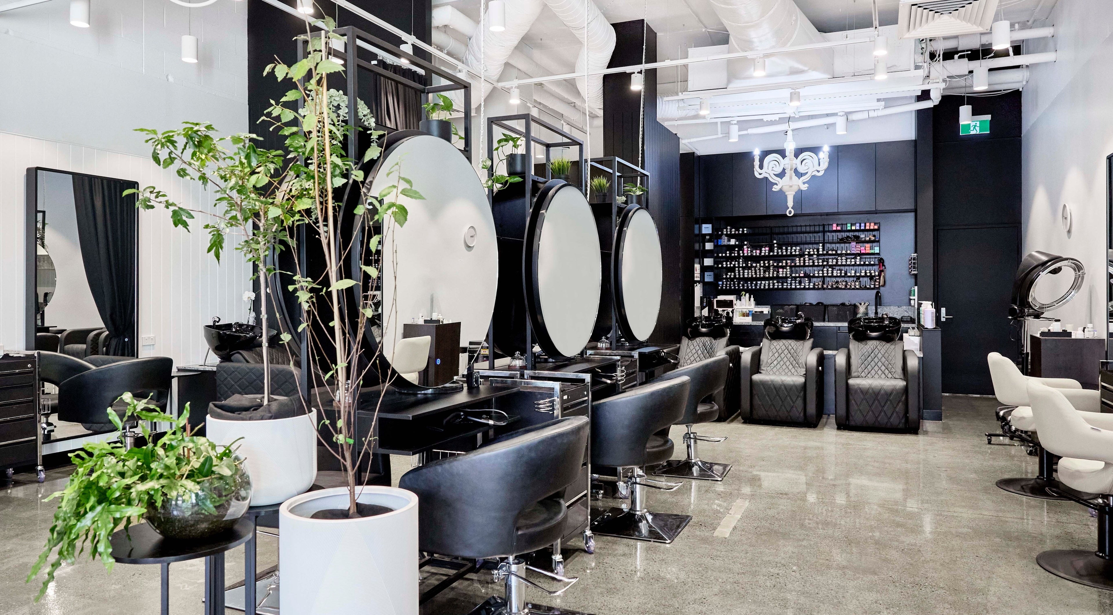 Modern interior of Studio 23 GC in Biggera Waters, Queensland, AU with stylish salon setup and lush plants.