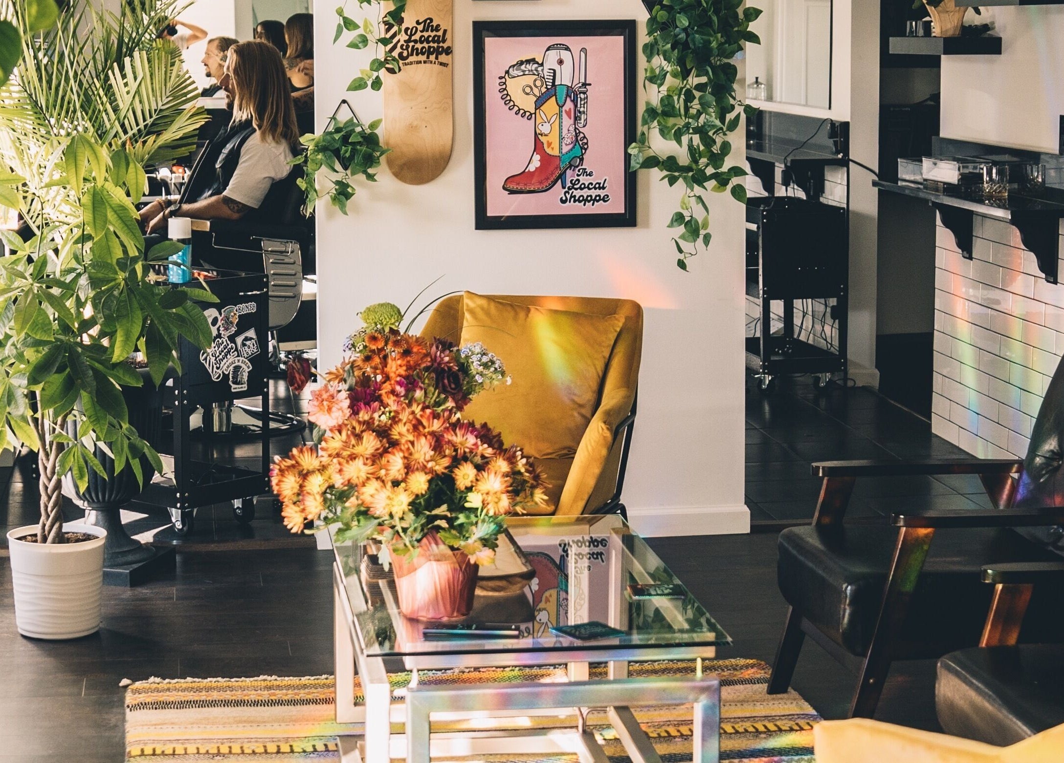 Inviting salon at The Local Shoppe with plants and vibrant seating in Charleston, South Carolina, US.