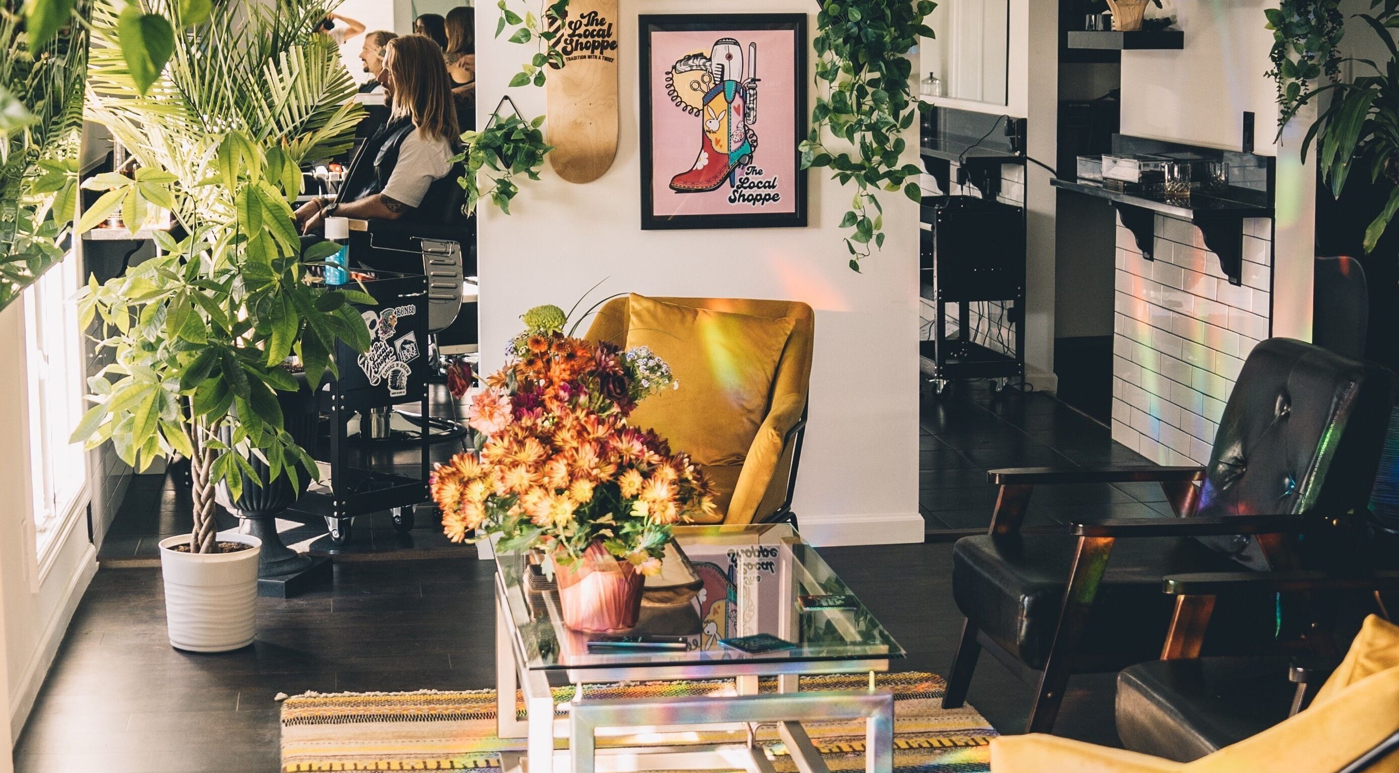 Inviting salon at The Local Shoppe with plants and vibrant seating in Charleston, South Carolina, US.