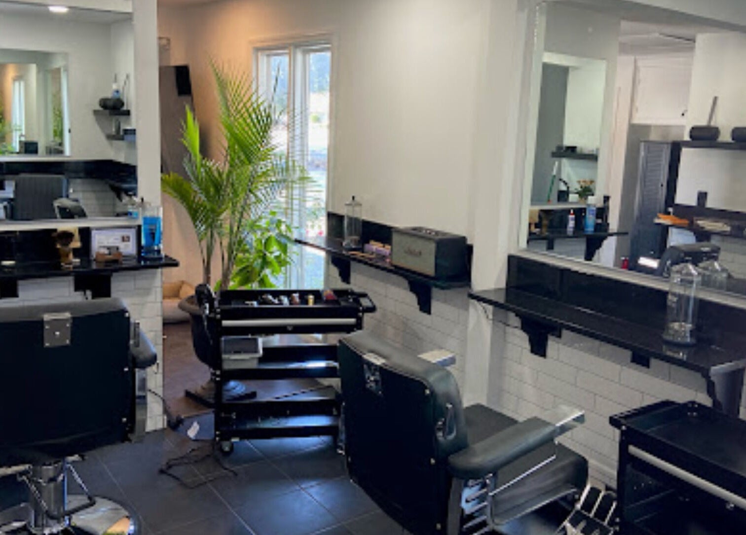 Modern salon interior at The Local Shoppe in Charleston, South Carolina, US, featuring stylish chairs and mirrors.