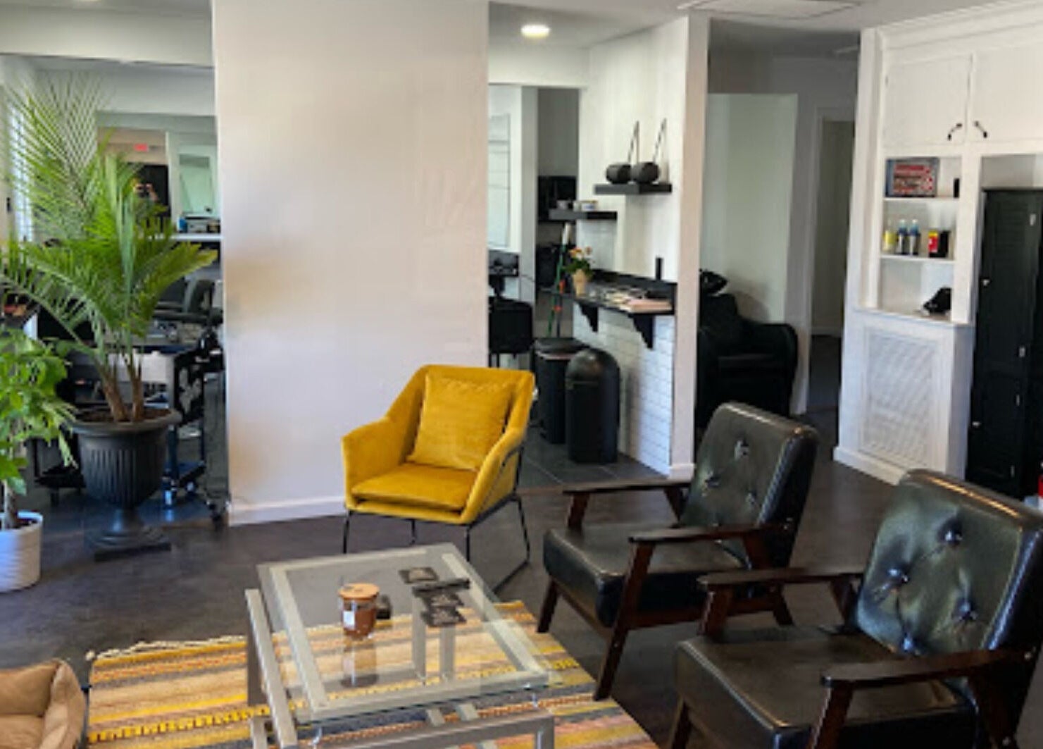Cozy seating area in The Local Shoppe, Charleston, South Carolina, US, with plants and modern decor.