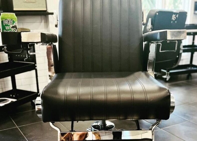 Sleek barber chair at The Local Shoppe offering premium grooming in Charleston, South Carolina, US.