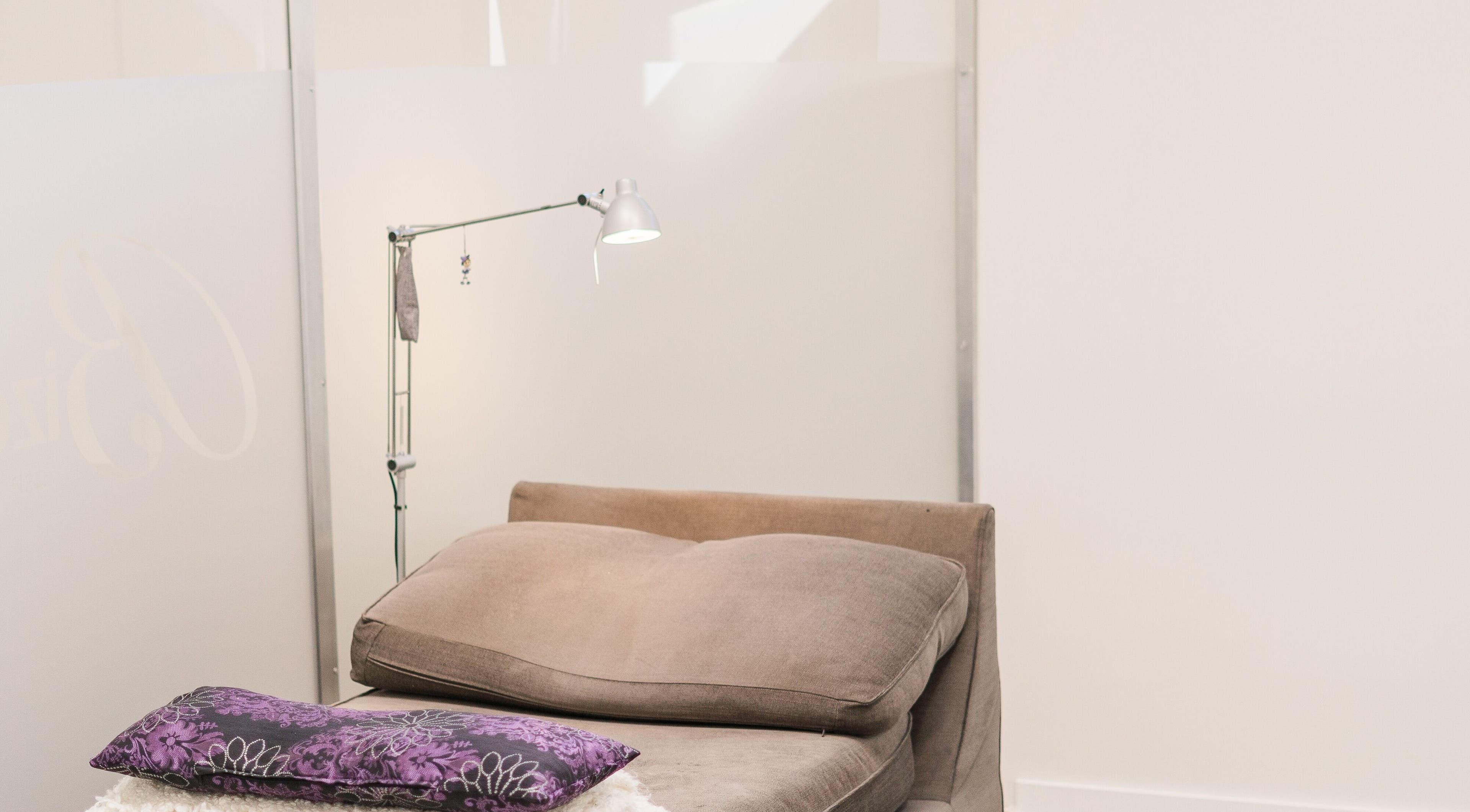 Elegant lash lounge at Bizou Lash Studio, Sherwood Park, Alberta, CA, featuring a plush chair and unique lighting.