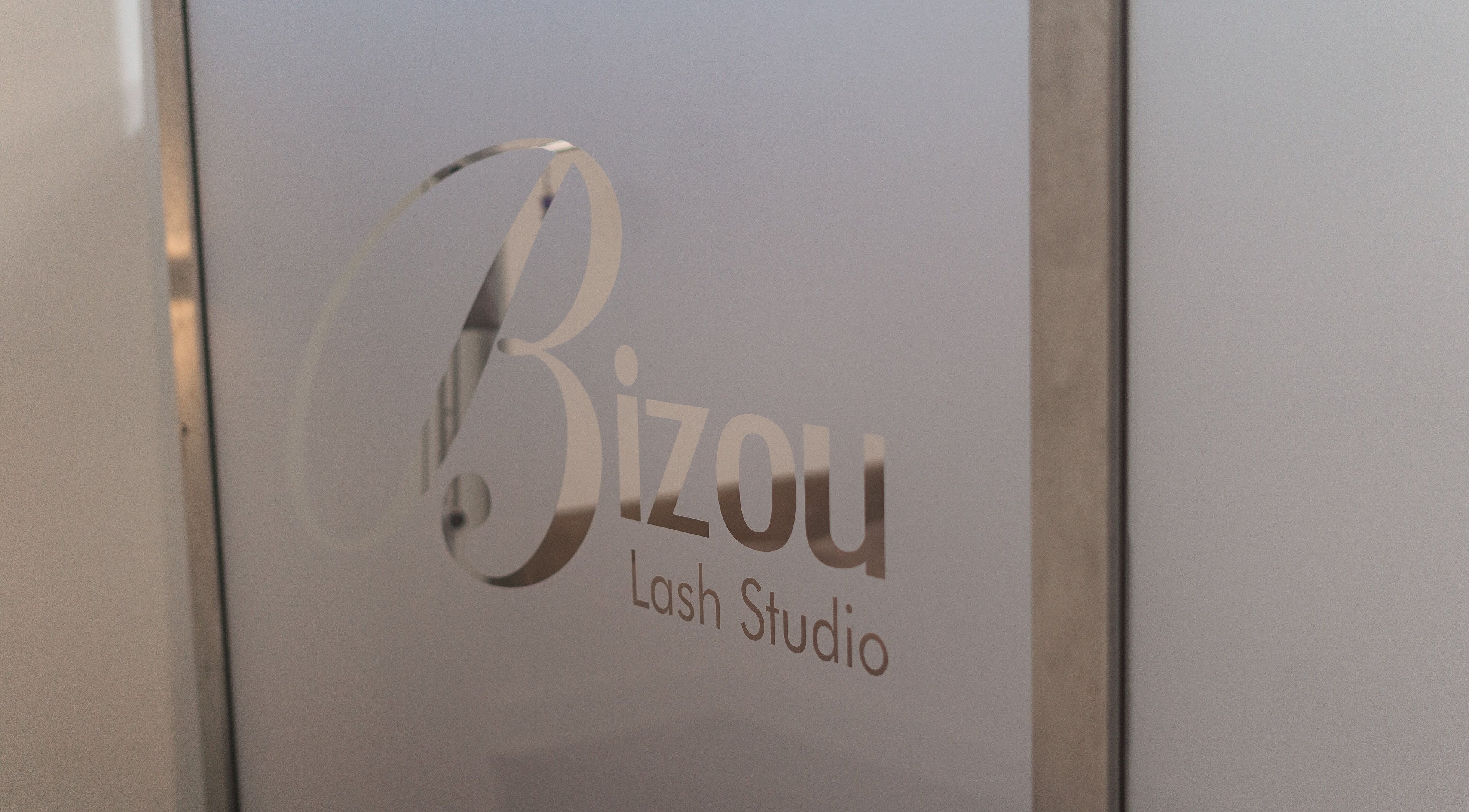 Elegant glass door with Bizou Lash Studio logo in Sherwood Park, Alberta, CA.