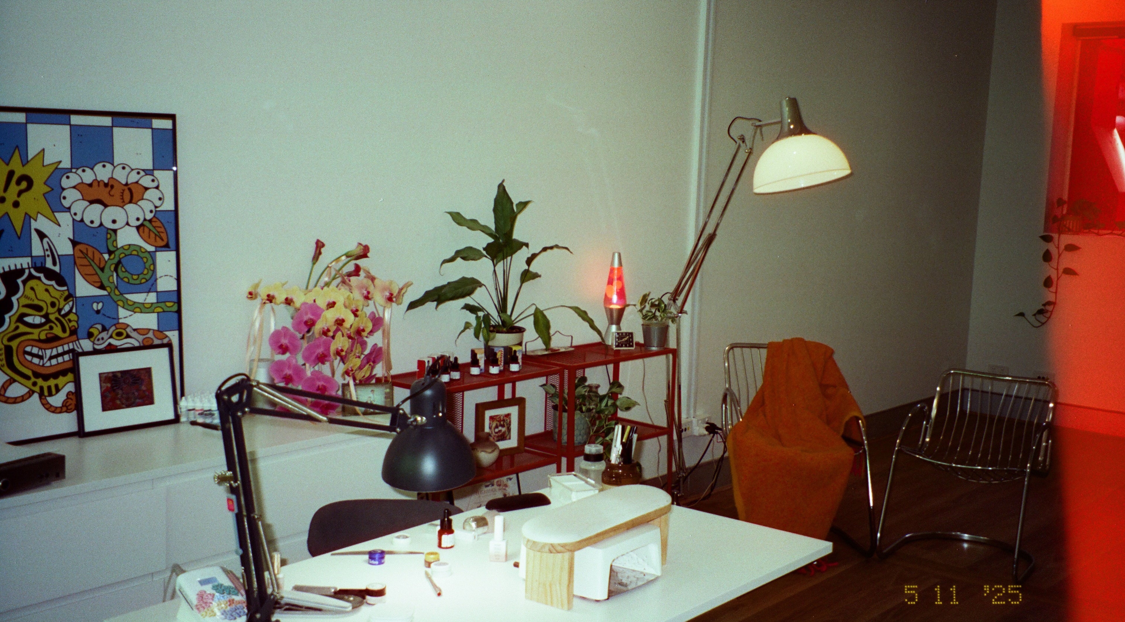 Inviting workspace at Studio412, Kingston, Australian Capital Territory, AU with plants, art, and a lava lamp.