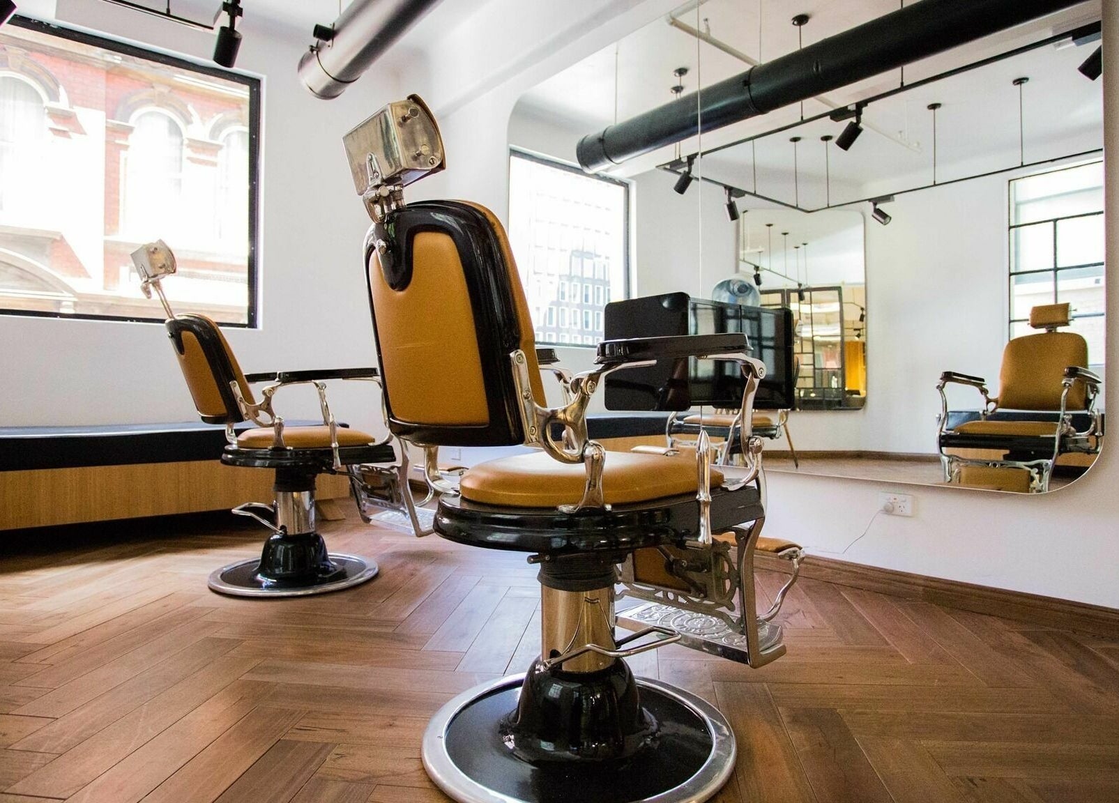Chic barber chairs in Aloyh Studio, East Melbourne, Victoria, AU, offer vintage elegance and modern comfort.