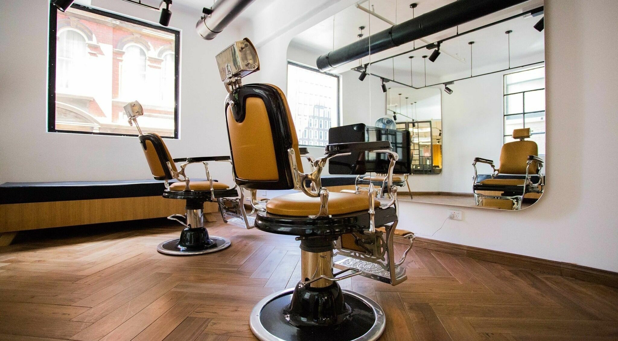 Chic barber chairs in Aloyh Studio, East Melbourne, Victoria, AU, offer vintage elegance and modern comfort.