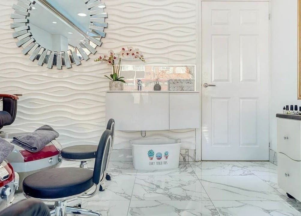 Sophisticated salon interior at Regal Nails, Croydon, England, GB with plush seating and modern decor.