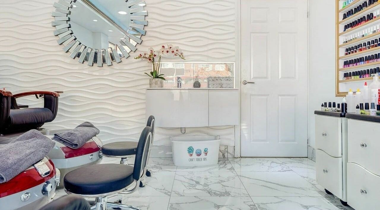 Sophisticated salon interior at Regal Nails, Croydon, England, GB with plush seating and modern decor.