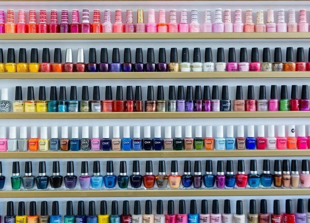 Vibrant nail polish selection at Regal Nails, Croydon, England, GB, showcasing a rainbow of colors.