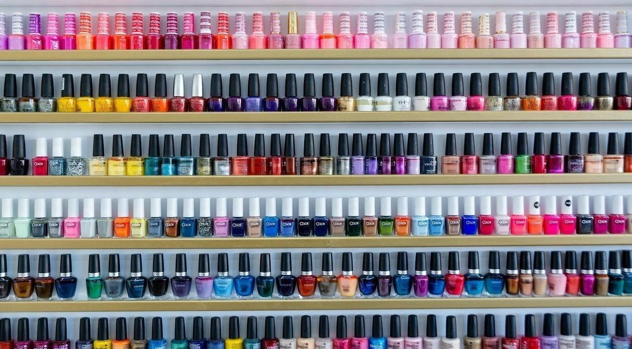 Vibrant nail polish selection at Regal Nails, Croydon, England, GB, showcasing a rainbow of colors.