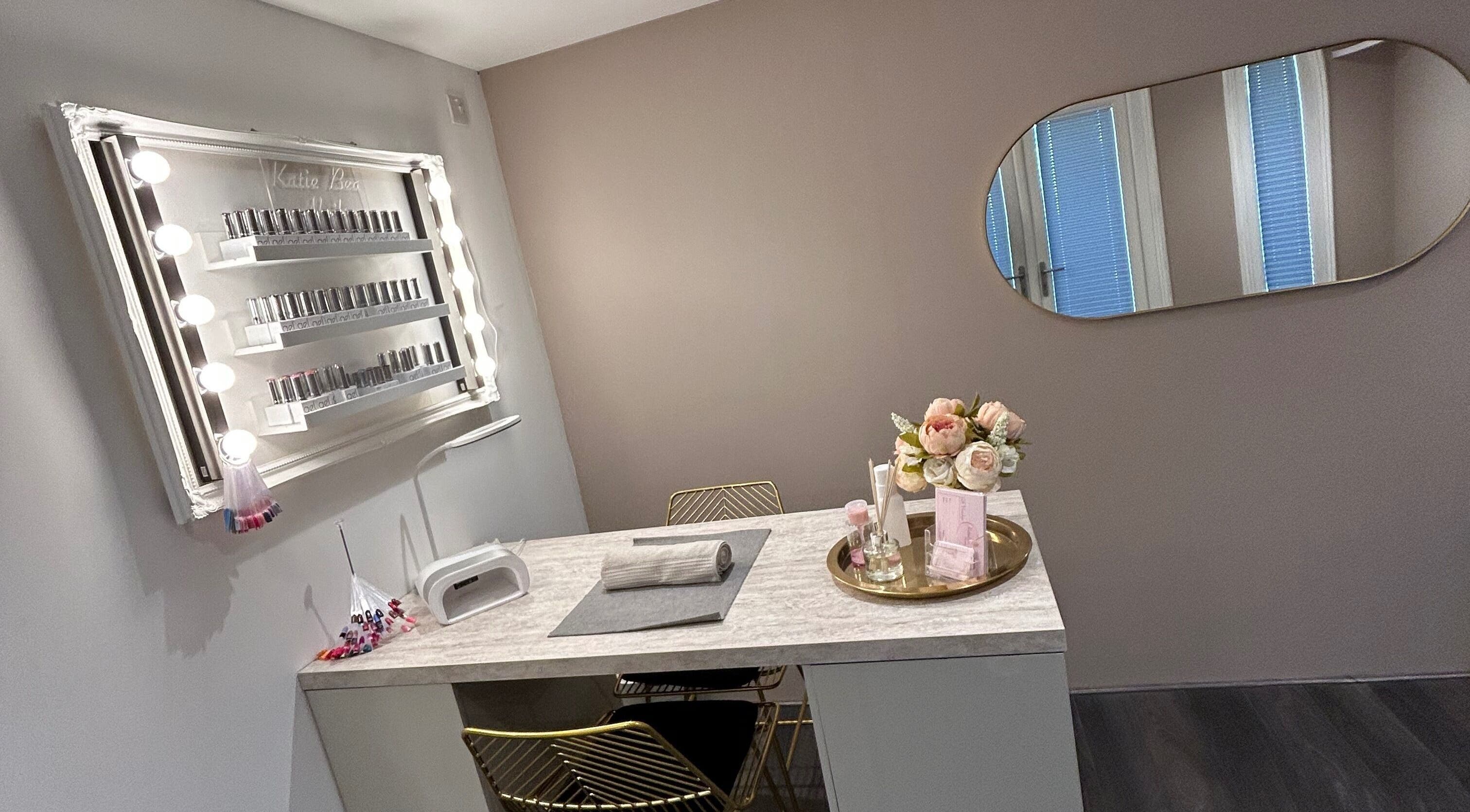 Chic nail station at KatieBea Beauty in Dundee, Scotland, GB. Features a mirror, nail polish display, and flowers.