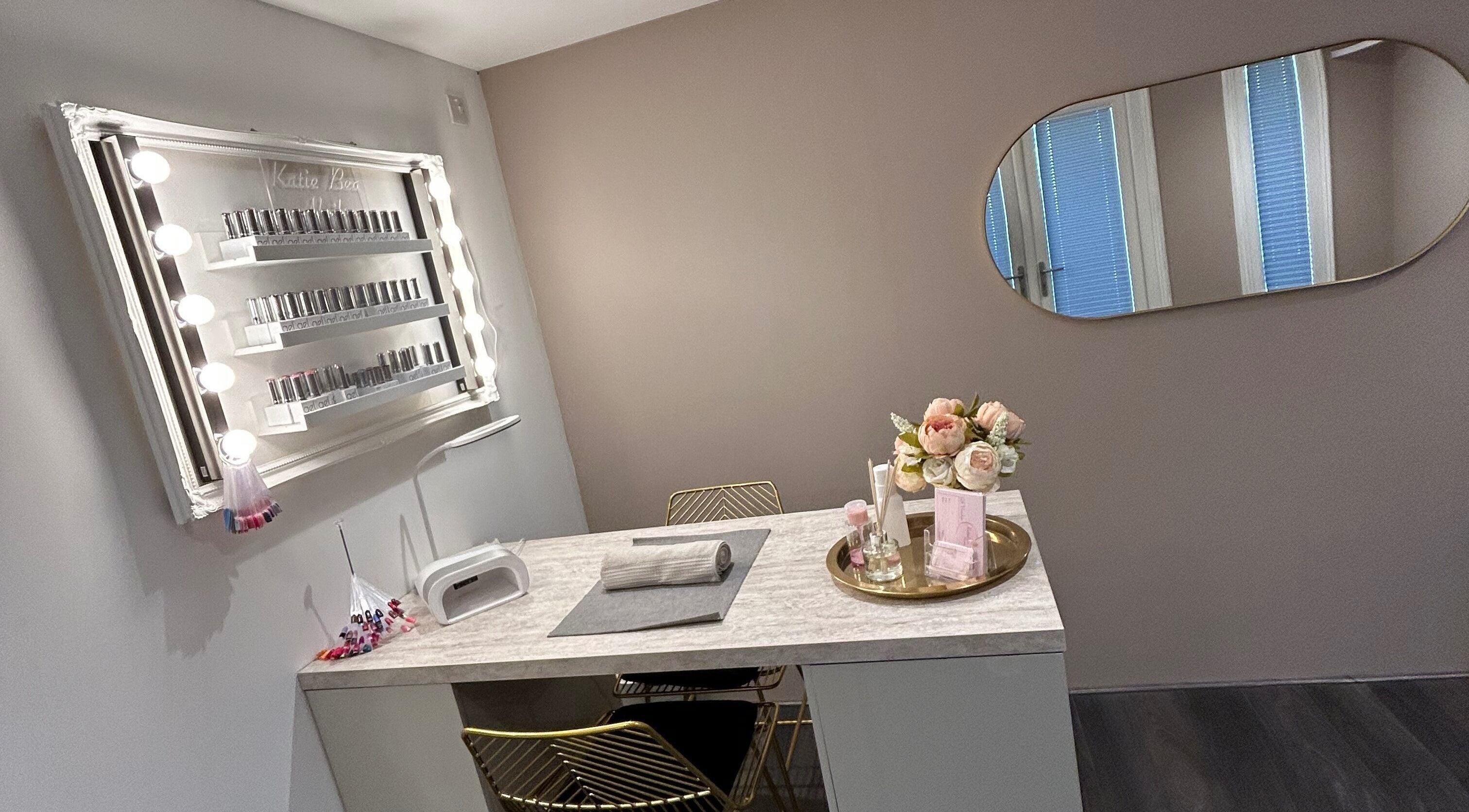 Chic nail station at KatieBea Beauty in Dundee, Scotland, GB. Features a mirror, nail polish display, and flowers.