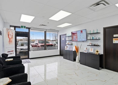 Elegant reception area at Beauty Matched Med Spa in Sarnia, Ontario, CA featuring modern decor and seating.