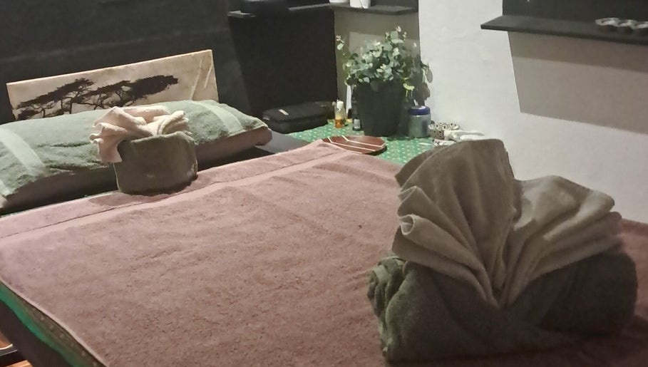Relaxing spa table setup at Body & Soul Thai Day Spa, Randburg, Gauteng, ZA, with towels and decor.