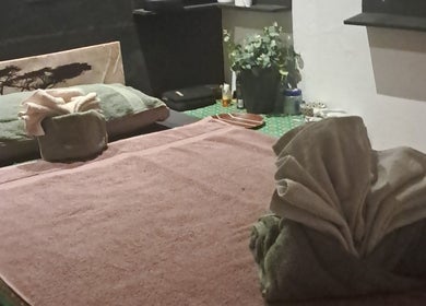 Relaxing spa table setup at Body & Soul Thai Day Spa, Randburg, Gauteng, ZA, with towels and decor.