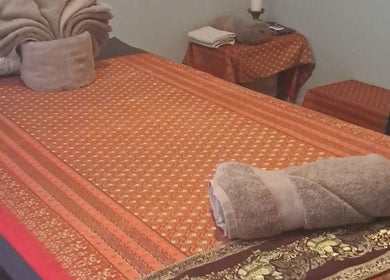 Relaxing massage bed setup at Body & Soul Thai Day Spa, Randburg, Gauteng, ZA, with traditional decor.