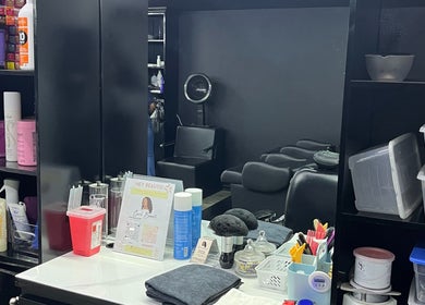 Curli Beauti a Division of ALMT Group Limited salon interior in Port of Spain, featuring styling products and seating.