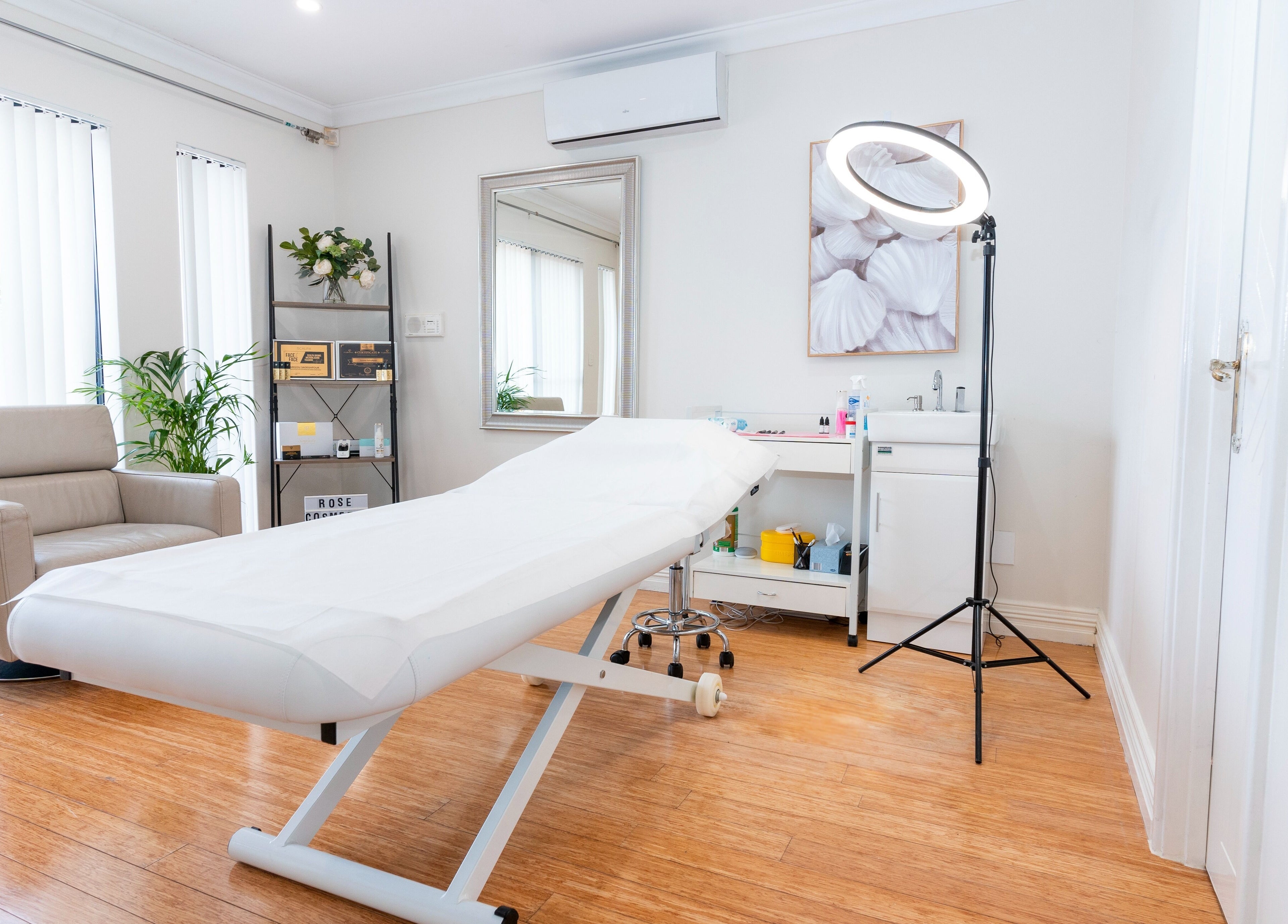 Spacious treatment room at Rose Clinic, North Perth, Western Australia, featuring a comfortable bed and stylish decor.
