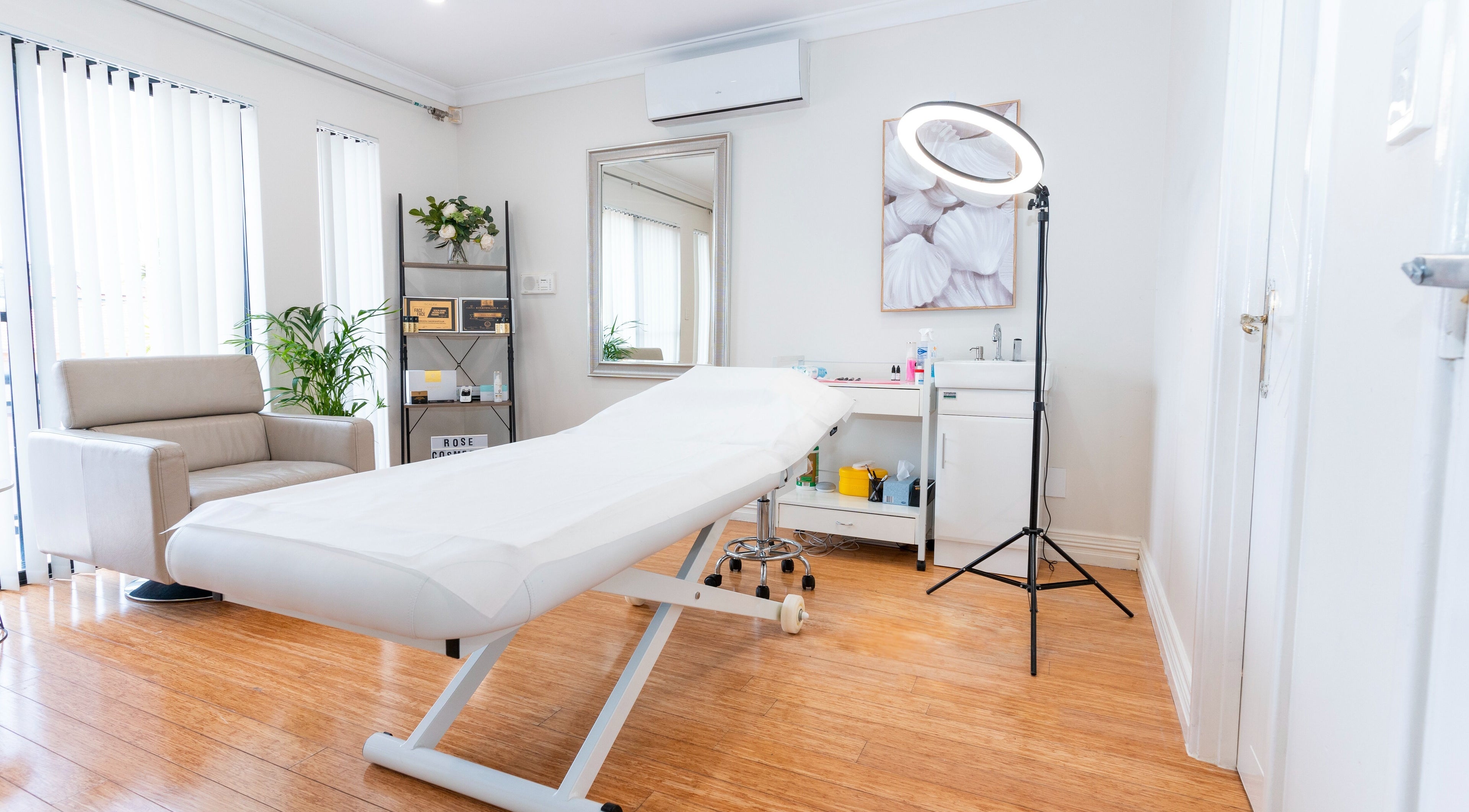 Spacious treatment room at Rose Clinic, North Perth, Western Australia, featuring a comfortable bed and stylish decor.