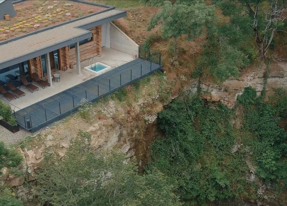 Aerial view of Banya No.1 Tbilisi Private in Kiketi, GE, featuring a serene deck with lounge chairs and lush surroundings.