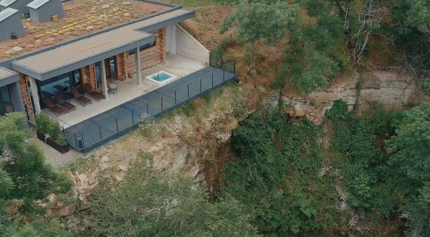 Aerial view of Banya No.1 Tbilisi Private in Kiketi, GE, featuring a serene deck with lounge chairs and lush surroundings.