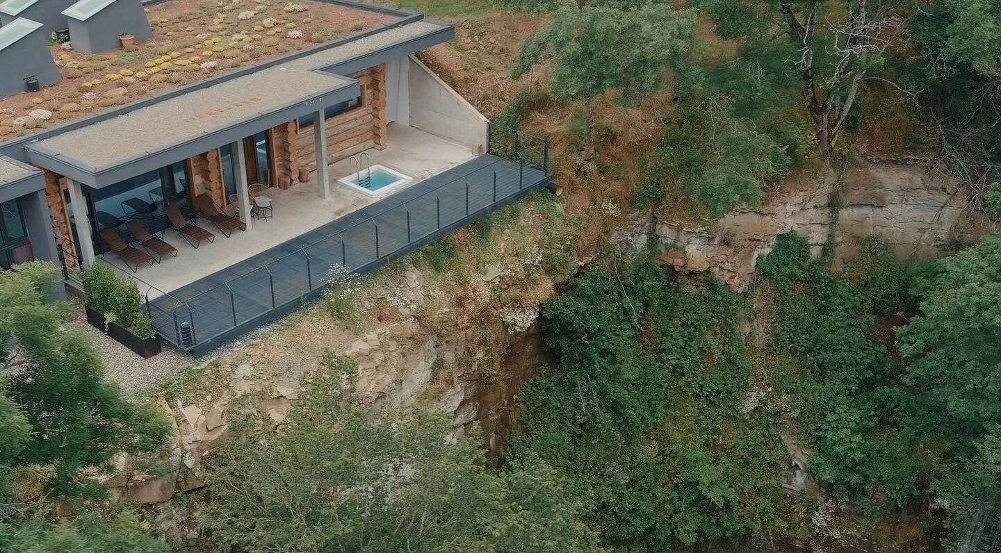 Aerial view of Banya No.1 Tbilisi Private in Kiketi, GE, featuring a serene deck with lounge chairs and lush surroundings.