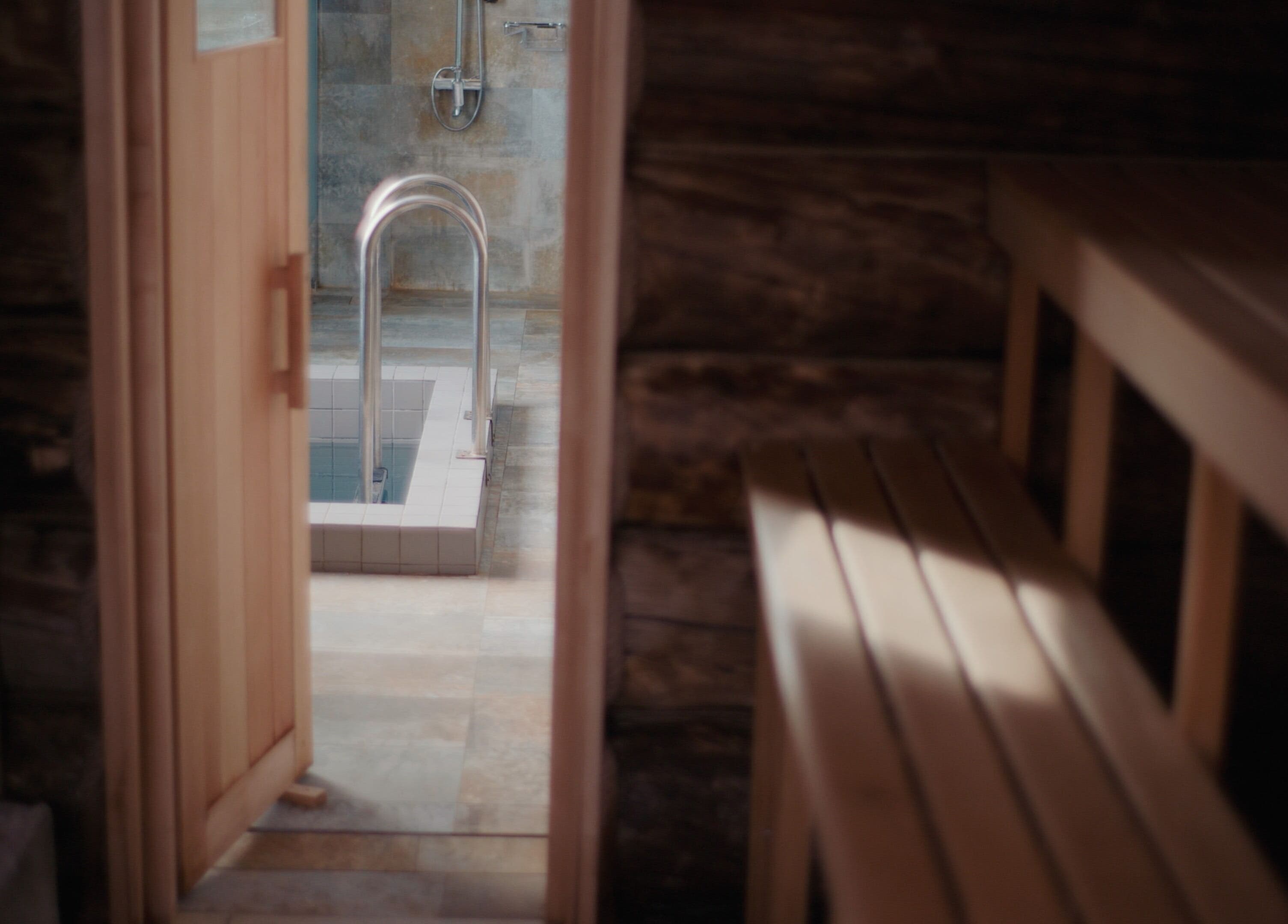 Relaxing bath area at Banya No.1 - Tbilisi, Kiketi, Kvemo Kartli, GE, featuring a wooden sauna and tiled tub.