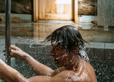 Person enjoying a refreshing water splash at Banya No.1 - Tbilisi (Public Mixed), Kiketi, Kvemo Kartli, GE.